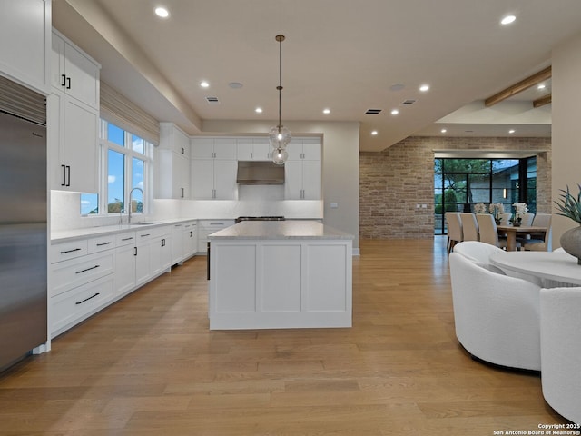 4701 Peralta Ln, Austin, TX 78735 - kitchen featuring stainless steel built in fridge, a center island, white cabinets, open floor plan, and recessed lighting