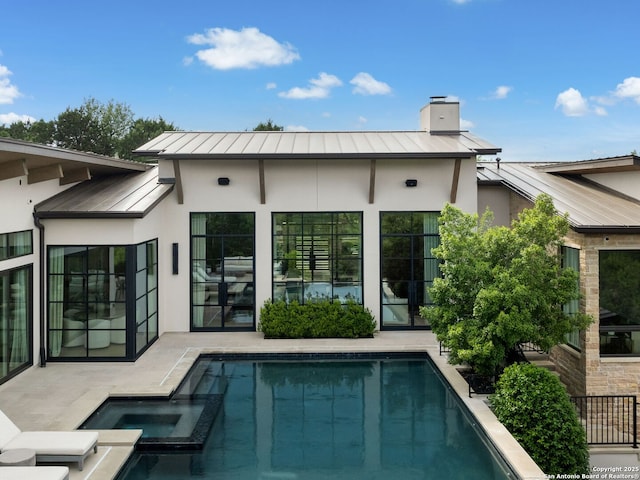 4701 Peralta Ln, Austin, TX 78735 - back of house featuring stucco siding, metal roof, a chimney, and a standing seam roof