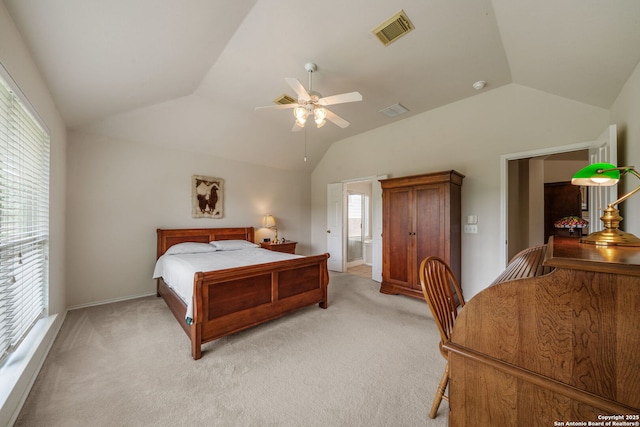 bedroom with light colored carpet, visible vents, and vaulted ceiling