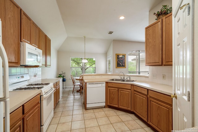 kitchen featuring visible vents, light tile patterned flooring, white appliances, a sink, and backsplash