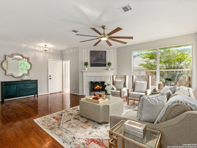 6027 Cedar Path, San Antonio, TX 78249 - living room featuring ceiling fan, a fireplace, wood finished floors, and visible vents