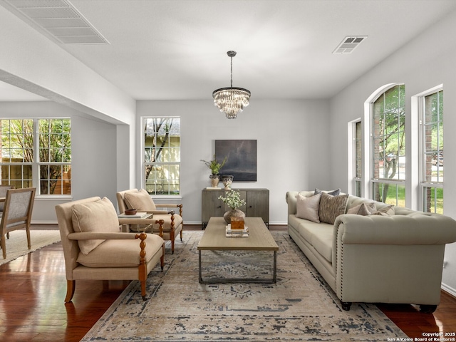6027 Cedar Path, San Antonio, TX 78249 - living area featuring visible vents, baseboards, wood finished floors, and a notable chandelier