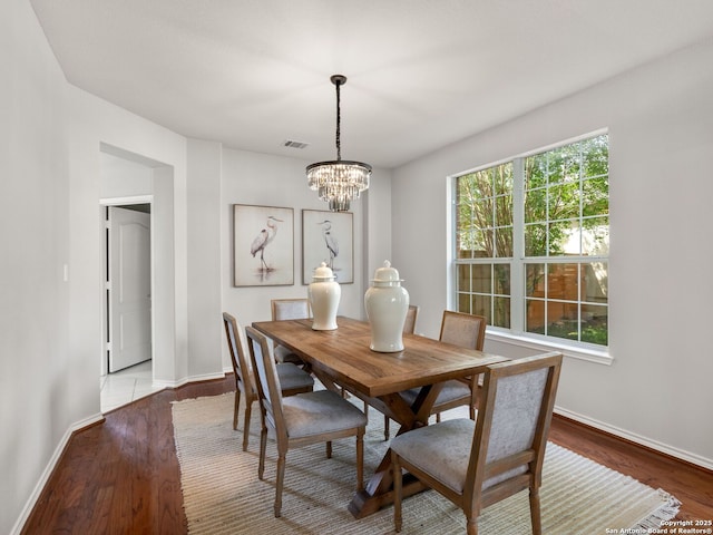 6027 Cedar Path, San Antonio, TX 78249 - dining space featuring visible vents, baseboards, wood finished floors, and a notable chandelier