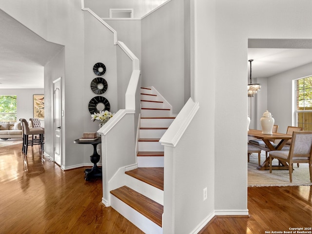 6027 Cedar Path, San Antonio, TX 78249 - stairway with baseboards, a chandelier, and wood finished floors