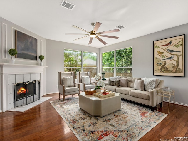 6027 Cedar Path, San Antonio, TX 78249 - living area featuring visible vents, ceiling fan, a tiled fireplace, and wood finished floors