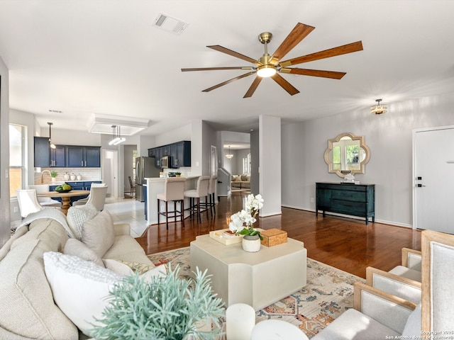 6027 Cedar Path, San Antonio, TX 78249 - living room featuring baseboards, ceiling fan, wood finished floors, and visible vents