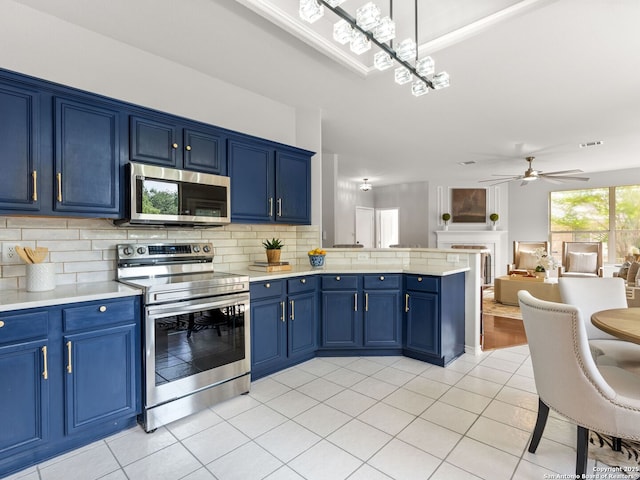 6027 Cedar Path, San Antonio, TX 78249 - kitchen featuring a peninsula, appliances with stainless steel finishes, tasteful backsplash, and blue cabinetry