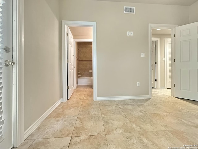 1262 Sleepy Holw, New Braunfels, TX 78130 - unfurnished bedroom with light tile patterned floors, baseboards, ensuite bathroom, and visible vents