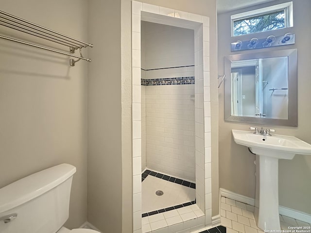 1262 Sleepy Holw, New Braunfels, TX 78130 - bathroom with tile patterned flooring, a sink, baseboards, toilet, and tiled shower