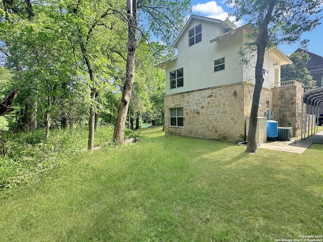 1262 Sleepy Holw, New Braunfels, TX 78130 - rear view of house with a yard, central AC, stone siding, and a detached carport