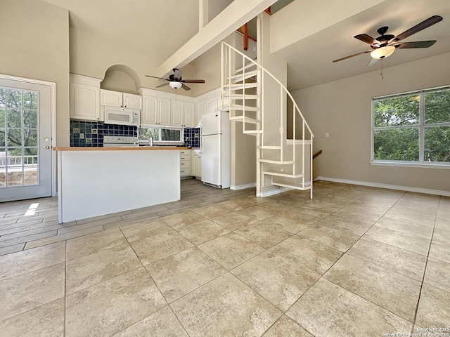 1262 Sleepy Holw, New Braunfels, TX 78130 - kitchen with ceiling fan, tasteful backsplash, high vaulted ceiling, white cabinets, and white appliances