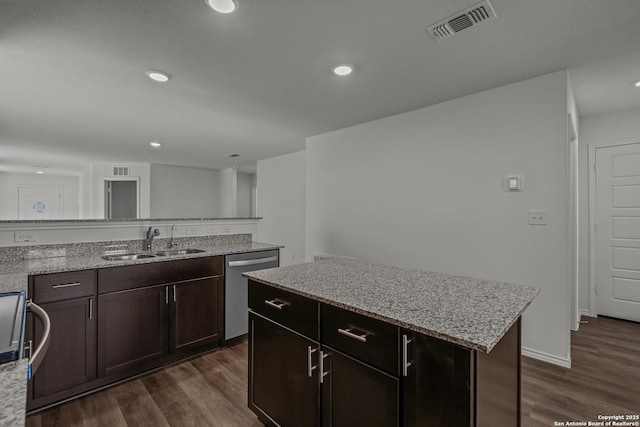 kitchen featuring a sink, stainless steel dishwasher, dark wood finished floors, and visible vents