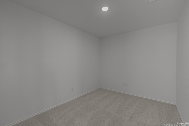 carpeted empty room featuring baseboards and recessed lighting