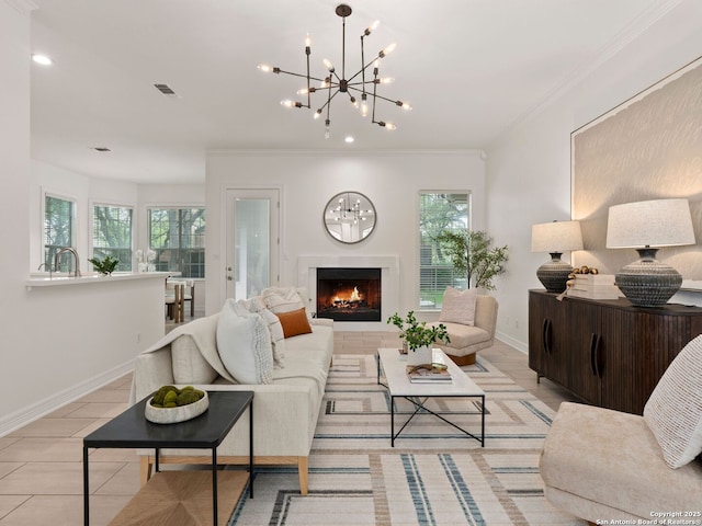 living room featuring an inviting chandelier, baseboards, crown molding, and recessed lighting