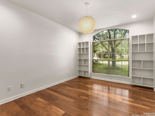 unfurnished dining area with baseboards, recessed lighting, and wood finished floors