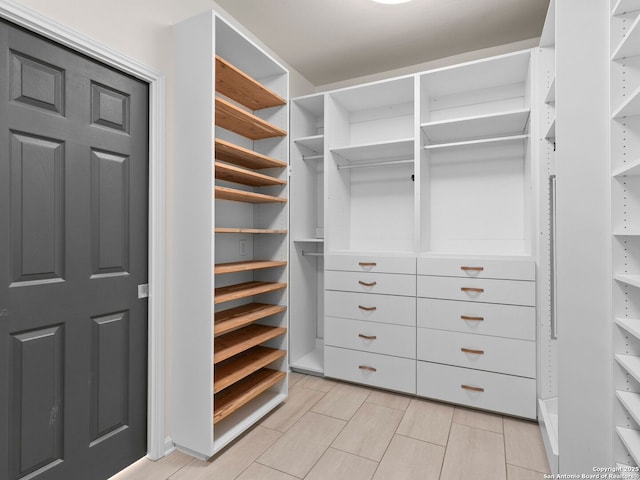 spacious closet featuring light tile patterned flooring