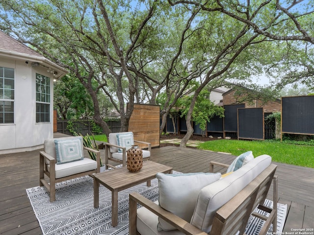 wooden deck featuring a fenced backyard and an outdoor living space