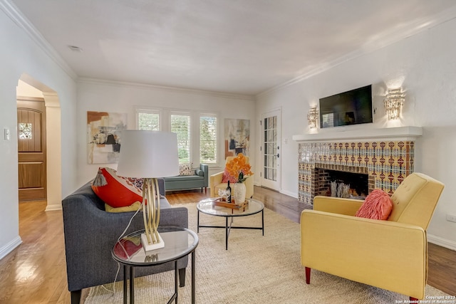 402 Thelma Dr, Olmos Park, TX 78212 - living area featuring ornamental molding, wood finished floors, a fireplace, baseboards, and arched walkways