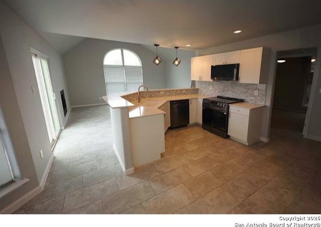 kitchen featuring decorative backsplash, pendant lighting, a peninsula, light countertops, and black appliances