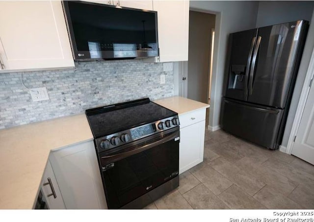 kitchen with decorative backsplash, light countertops, electric range oven, white cabinetry, and fridge with ice dispenser