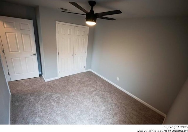 unfurnished bedroom with carpet floors, visible vents, a closet, baseboards, and ceiling fan