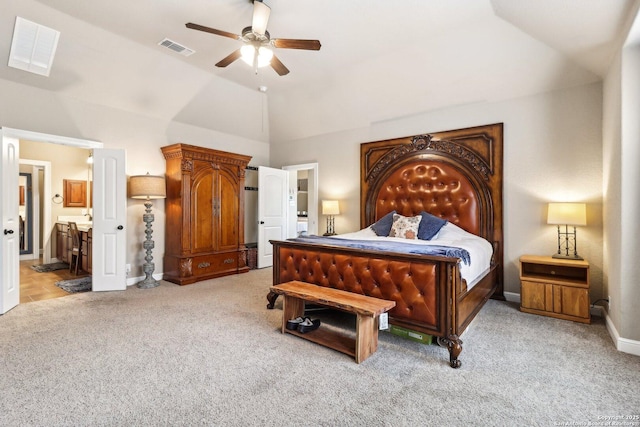 bedroom featuring light carpet, lofted ceiling, connected bathroom, and visible vents