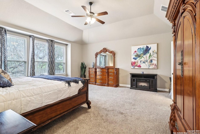 carpeted bedroom featuring visible vents, a ceiling fan, baseboards, and lofted ceiling