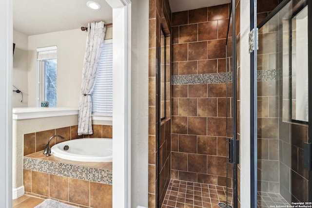 bathroom with a shower stall, recessed lighting, and a bath