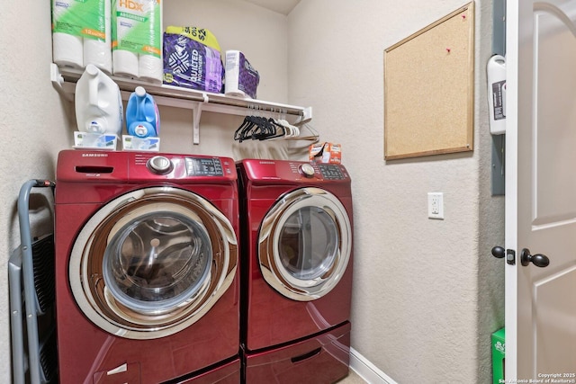 laundry room featuring laundry area, a textured wall, and independent washer and dryer