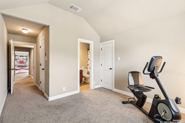 exercise area with baseboards, visible vents, carpet, and vaulted ceiling