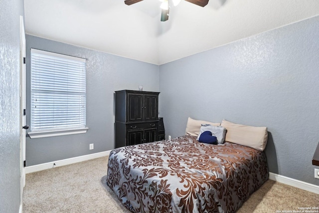 carpeted bedroom with baseboards, a textured wall, and a ceiling fan