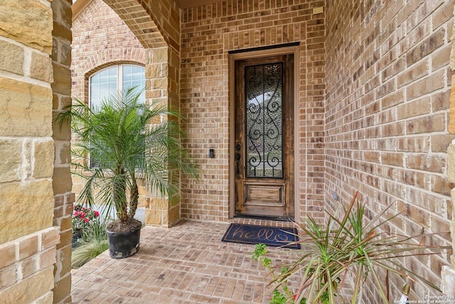 entrance to property with brick siding and stone siding