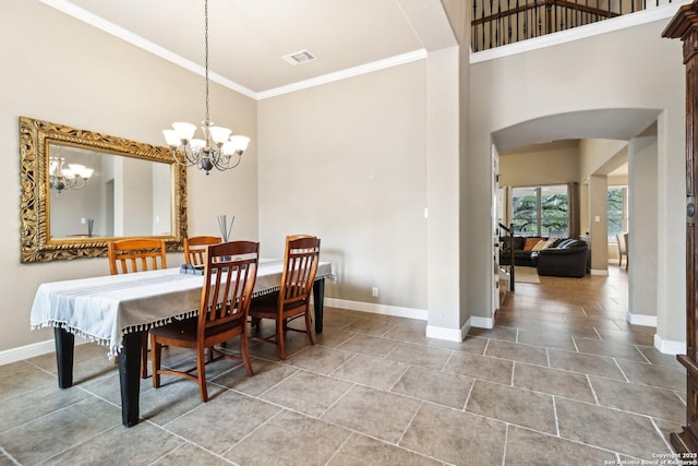 dining space featuring visible vents, arched walkways, baseboards, and a high ceiling