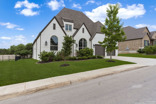 view of front of property with brick siding, a garage, a front yard, and concrete driveway