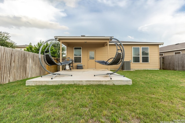 back of property featuring a fenced backyard, a yard, and a patio area
