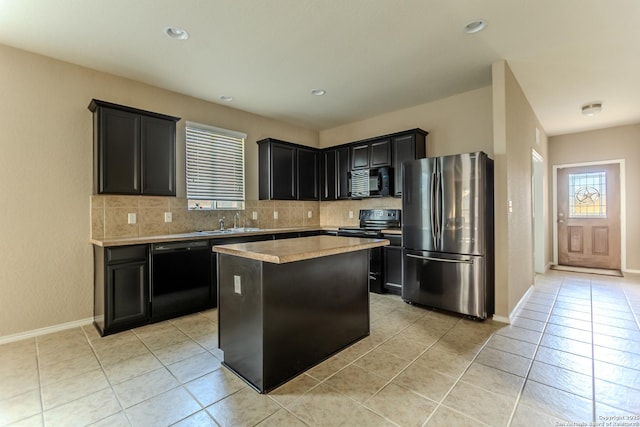 kitchen featuring decorative backsplash, a sink, black appliances, and a wealth of natural light