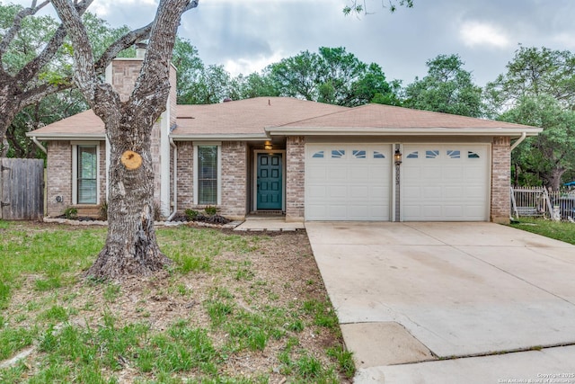 single story home with driveway, brick siding, fence, an attached garage, and a shingled roof