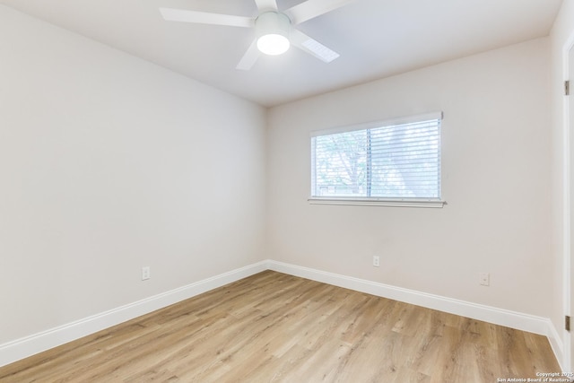 spare room featuring baseboards, a ceiling fan, and light wood finished floors
