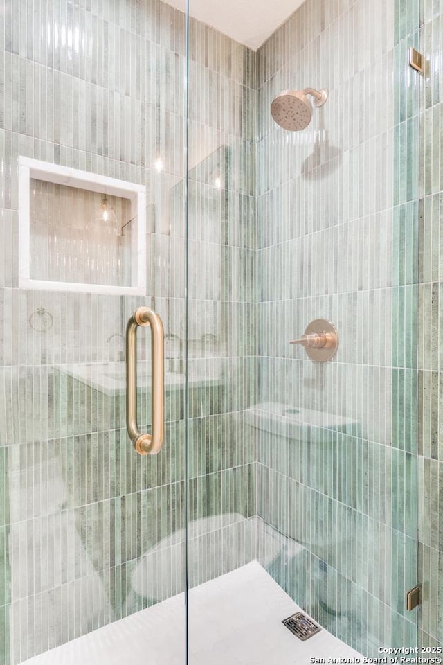 bathroom featuring a shower stall