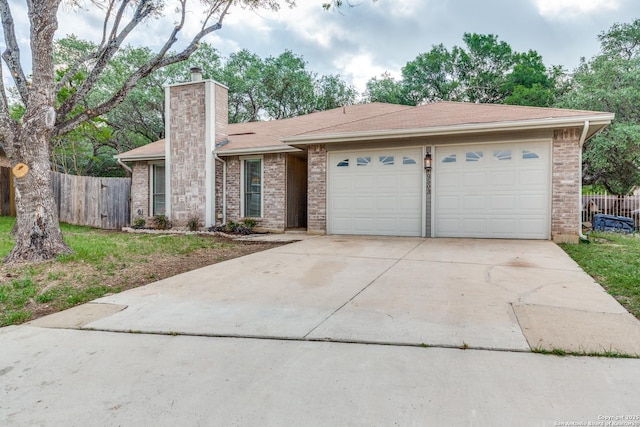 ranch-style house with driveway, a chimney, brick siding, fence, and an attached garage