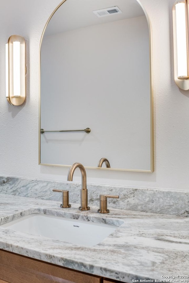 room details featuring arched walkways, visible vents, and vanity
