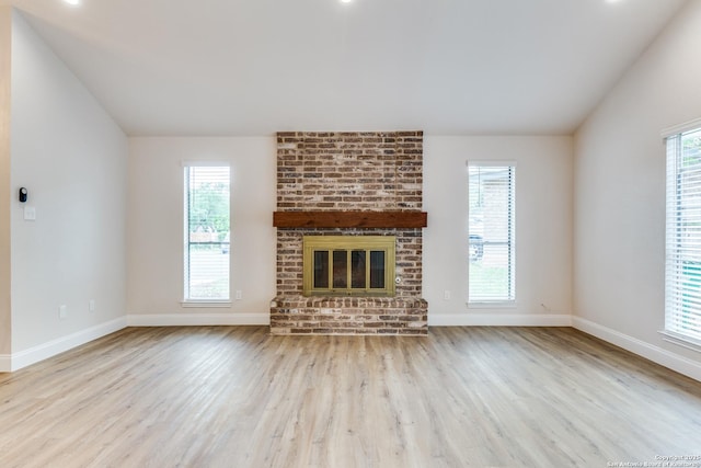 unfurnished living room featuring baseboards, vaulted ceiling, and wood finished floors