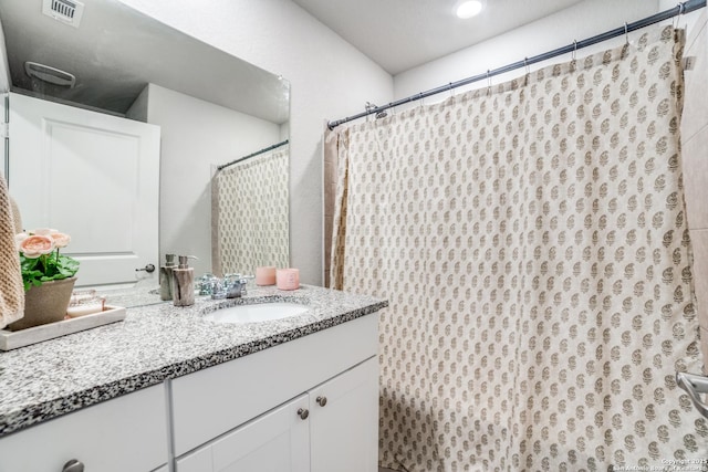 full bathroom with visible vents and vanity