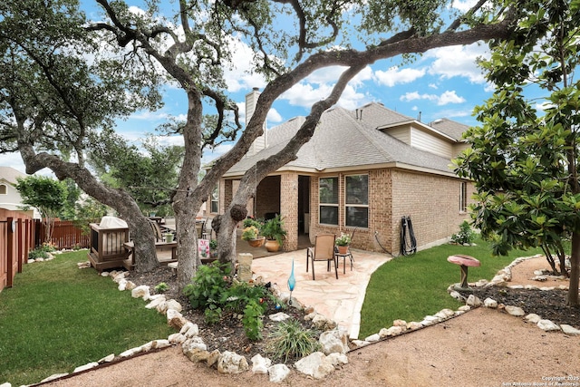 3811 Valencia Ct, San Antonio, TX 78259 - rear view of property with brick siding, roof with shingles, a patio area, and a chimney