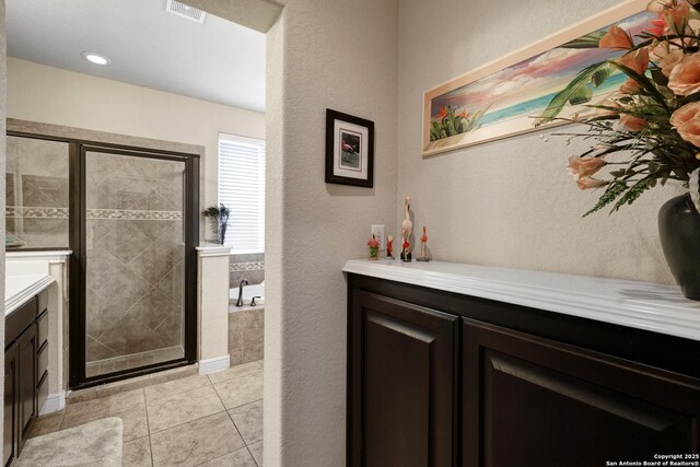 3811 Valencia Ct, San Antonio, TX 78259 - bathroom with vanity, a shower stall, a bath, and tile patterned flooring
