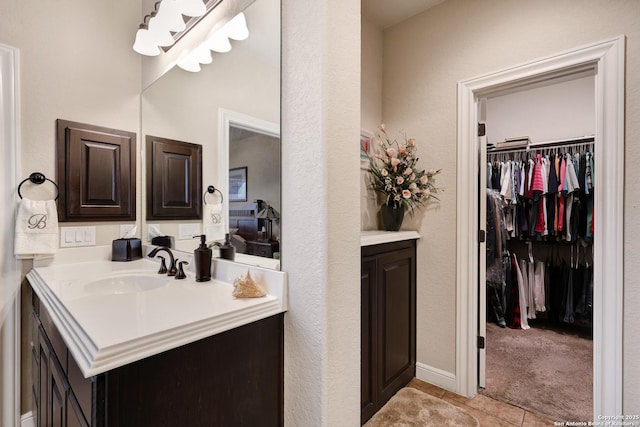 3811 Valencia Ct, San Antonio, TX 78259 - bathroom featuring vanity, a spacious closet, and tile patterned flooring