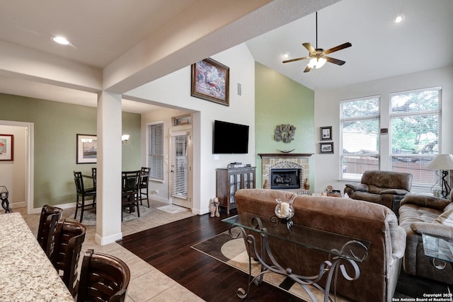 3811 Valencia Ct, San Antonio, TX 78259 - living area featuring ceiling fan, a fireplace with raised hearth, vaulted ceiling, recessed lighting, and wood finished floors