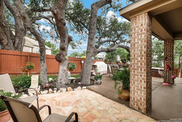 3811 Valencia Ct, San Antonio, TX 78259 - fenced backyard featuring a deck and a patio area