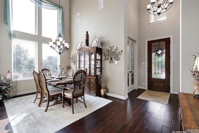 3811 Valencia Ct, San Antonio, TX 78259 - dining space with a chandelier, a towering ceiling, dark wood finished floors, and baseboards