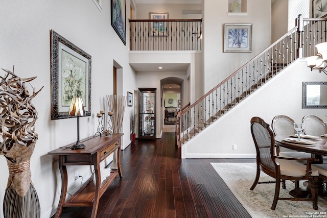 3811 Valencia Ct, San Antonio, TX 78259 - entrance foyer with a towering ceiling, stairway, baseboards, arched walkways, and wood finished floors